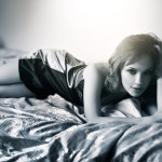 Young beautiful woman lying on a bed