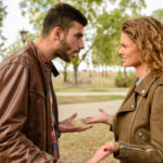 Young couple having a debate in the public park