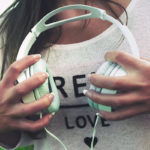 Canva – Woman Holding White Corded Headphones