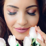 photography-of-a-woman-holding-white-flowers-931004