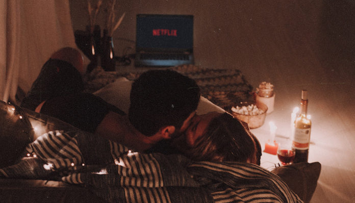couple-kissing-on-a-couch-4395196