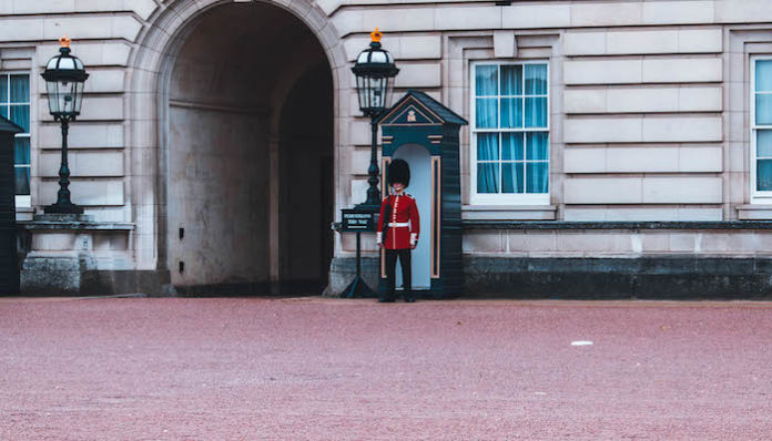 royal-guard-standing-beside-building-1560101