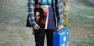 4 Reasons Vinyl Is The Best Way To Experience Music person holding vinyl