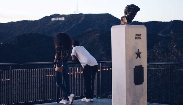 man-and-woman-standing-near-black-metal-railings-935984