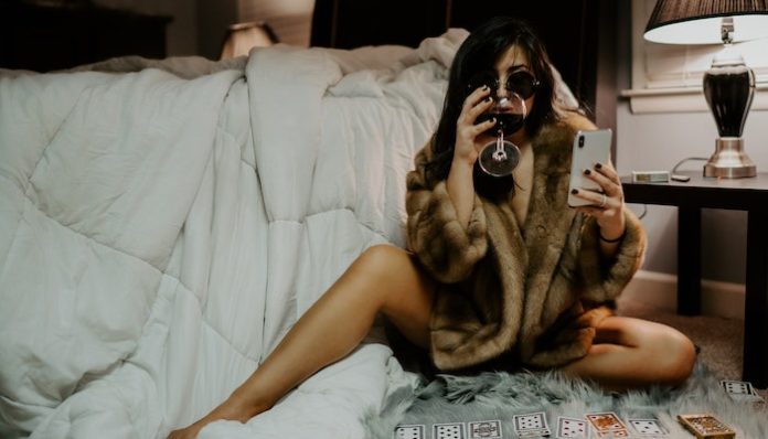 sexting phone bed woman wine