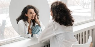 This Is How I Finally Reclaimed My Femininity woman-seeing-femininity-in-mirror
