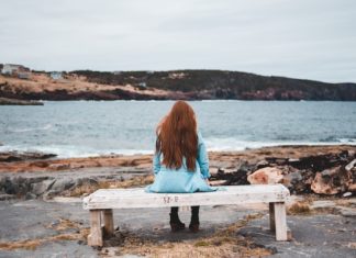 This Pain of Grief Will Be With Me Forever, But This Pandemic Doesn’t Have To Be grieving woman on bench