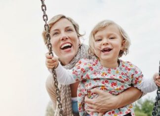 mother and baby on swing