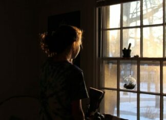 5 Tips For Healing From Your Childhood Trauma lonely woman standing by window