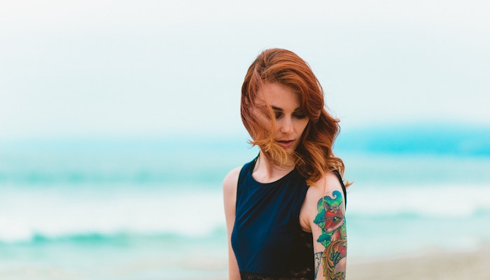 Woman With Tattoo On Arm
