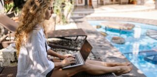 How To Choose The Best Accommodation For A Digital Nomad Woman Working By Accommodation Pool As Digital Nomad