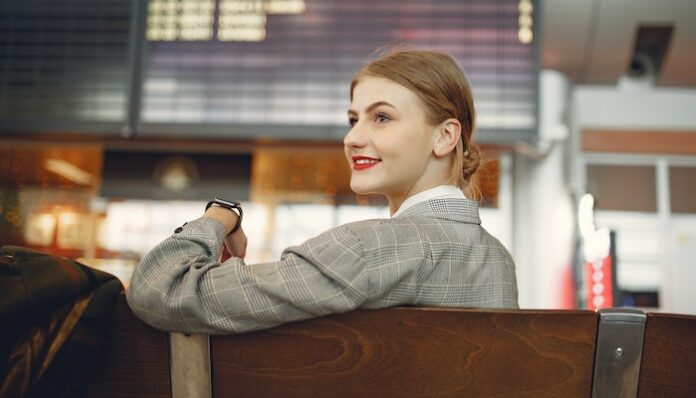 Woman In Airport Before Flight Woman Playing Crossword Puzzle in Airport Before Flight