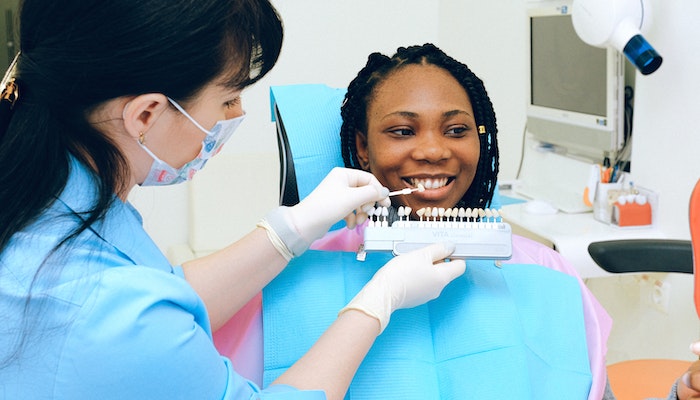 Woman Fixing Teeth At Dentist
