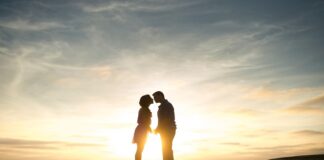 Open Marriages Are Not The Future, And That’s A Good Thing Couple kissing at sunset near water