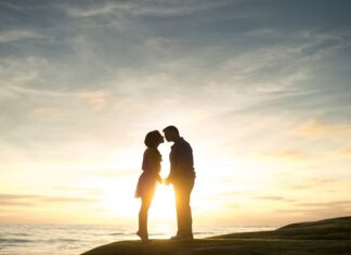 Open Marriages Are Not The Future, And That’s A Good Thing Couple kissing at sunset near water