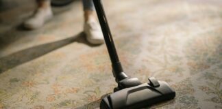 5 Household Gadgets You Need For Your Place Woman Using Cordless Vacuum