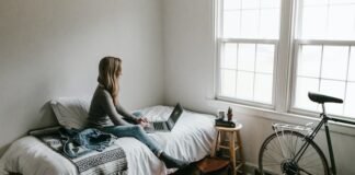 7 Mood-Boosting Decorating Tips For Your Bedroom woman changing bedroom decor