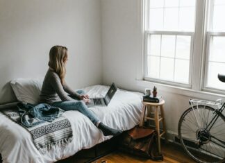 woman changing bedroom decor