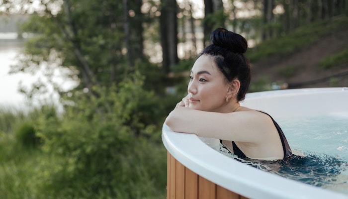 Woman Enjoying Backyard Hot Tub