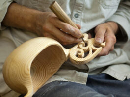 Man Performing Wood Carving and Engraving