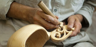 Man Performing Wood Carving and Engraving