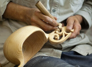 Man Performing Wood Carving and Engraving
