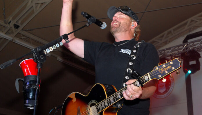Playing to the base: Toby Keith sings at Camp Buehring during his 'Live In Overdrive' USO tour toby-keith