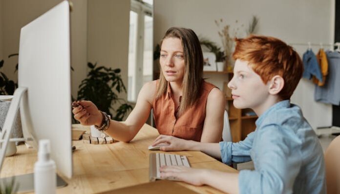 Mom and Son Making Digital Journal of Teen Years