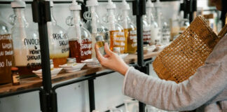 Woman Looking at Shampoo With Plant Extracts