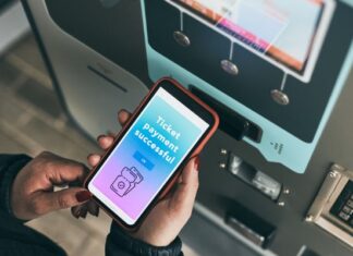Person Holding Digital Ticket on Mobile Device