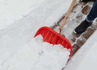 Woman Clearing Snow Without Snow Plowing Service