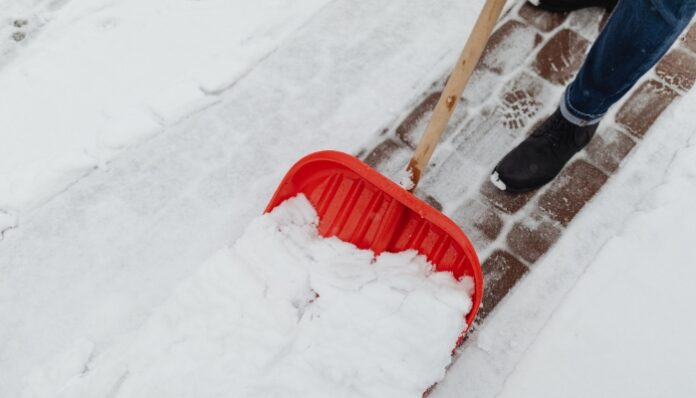 Snow Plow Services Woman Clearing Snow Without Snow Plowing Service