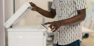Staff Member Using Fax Machine