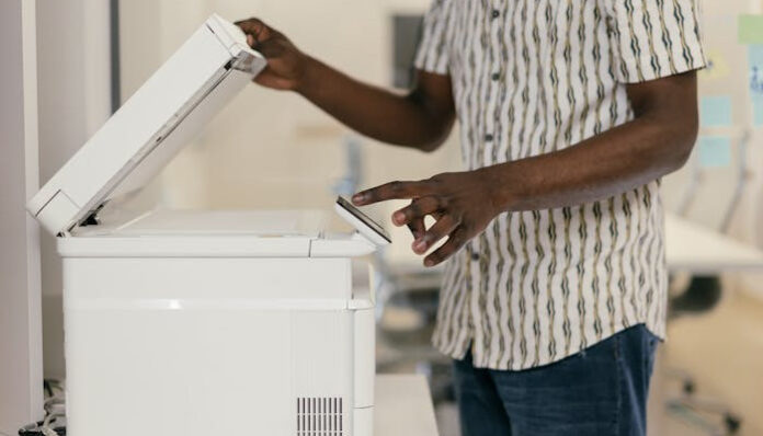 pexels-mikhail-nilov-9301887 Staff Member Using Fax Machine