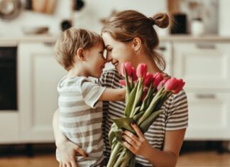 Woman Receiving Mother's Day Flowers from Son