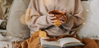 5 Ways to Lower Your Energy Bills This Winter Without Sacrificing Comfort Woman Staying Warm with Geothermal Heating