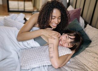 Couple in Bed Playfully Flirting