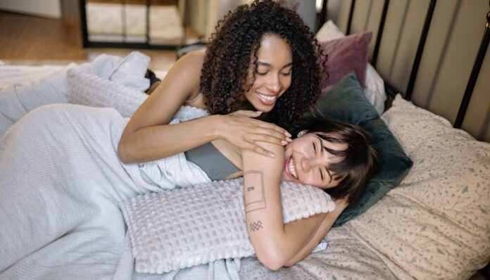 Couple in Bed Playfully Flirting