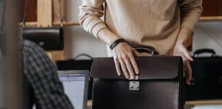 Employee Packing Items in Leather Laptop Briefcase