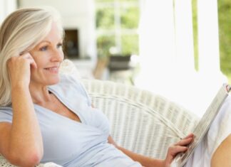Woman Sitting in the Sun Reading About Hormonal Imbalance