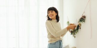 Woman Hanging Decor in New Home