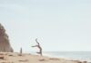 Woman Doing Cartwheels on Beach