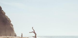 Woman Doing Cartwheels on Beach