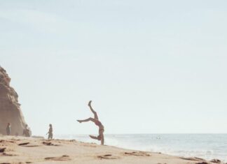 How I Made My Beach Days About Fun, Not Perfection Woman Doing Cartwheels on Beach