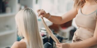 Woman Applying Hair Extensions for Friend