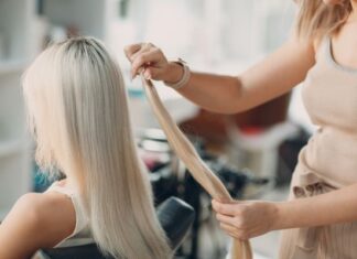 Woman Applying Hair Extensions for Friend