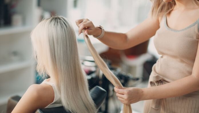 Hair Extensions Woman Applying Hair Extensions for Friend