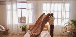 Avoid Hidden Dangers Lurking In Your Bed With Mattress Cleaning Woman making her bed