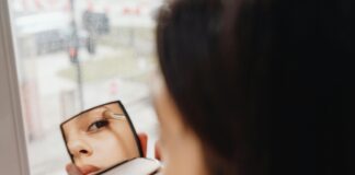 Woman Putting on New Makeup During Spring Rain