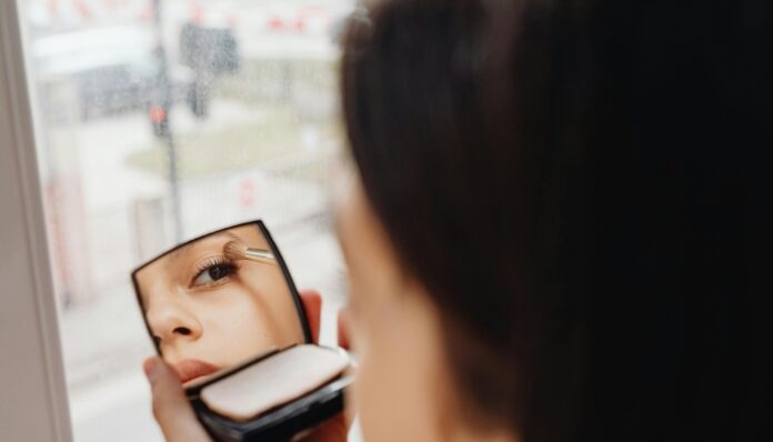 Spring Makeup Trends Woman Putting on New Makeup During Spring Rain